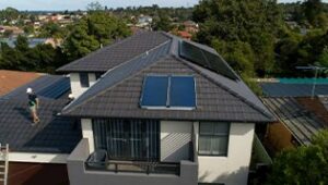 House in suburbia with a solar hot water system mounted on the roof